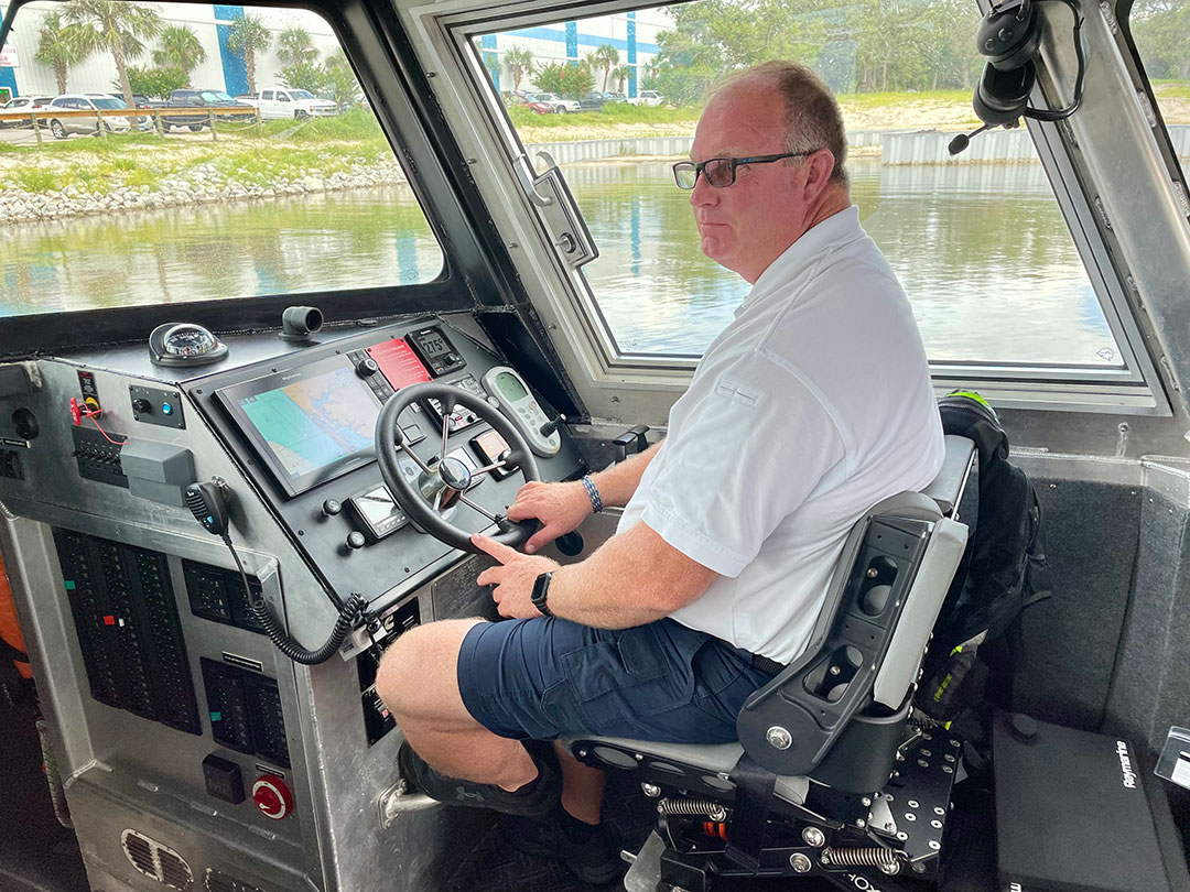 Battalion Chief Bruce Nelson sits within the well-appointed pilothouse equipped with Raymarine electronics.