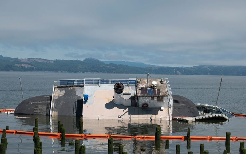 Tourist No. 2 was moored for two years in downtown Astoria. Its owner believes the vessel drifted atop nearby piers that punctured its hull. How the vessel came loose is unknown.