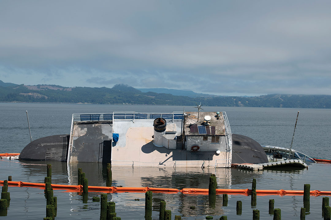 Tourist No. 2 was moored for two years in downtown Astoria. Its owner believes the vessel drifted atop nearby piers that punctured its hull. How the vessel came loose is unknown.