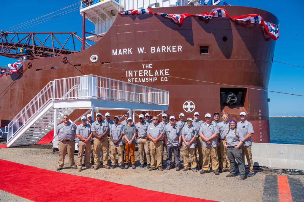 Crew aboard the 639-foot Mark W. Barker gather for a photo to mark the ship’s christening in Cleveland.