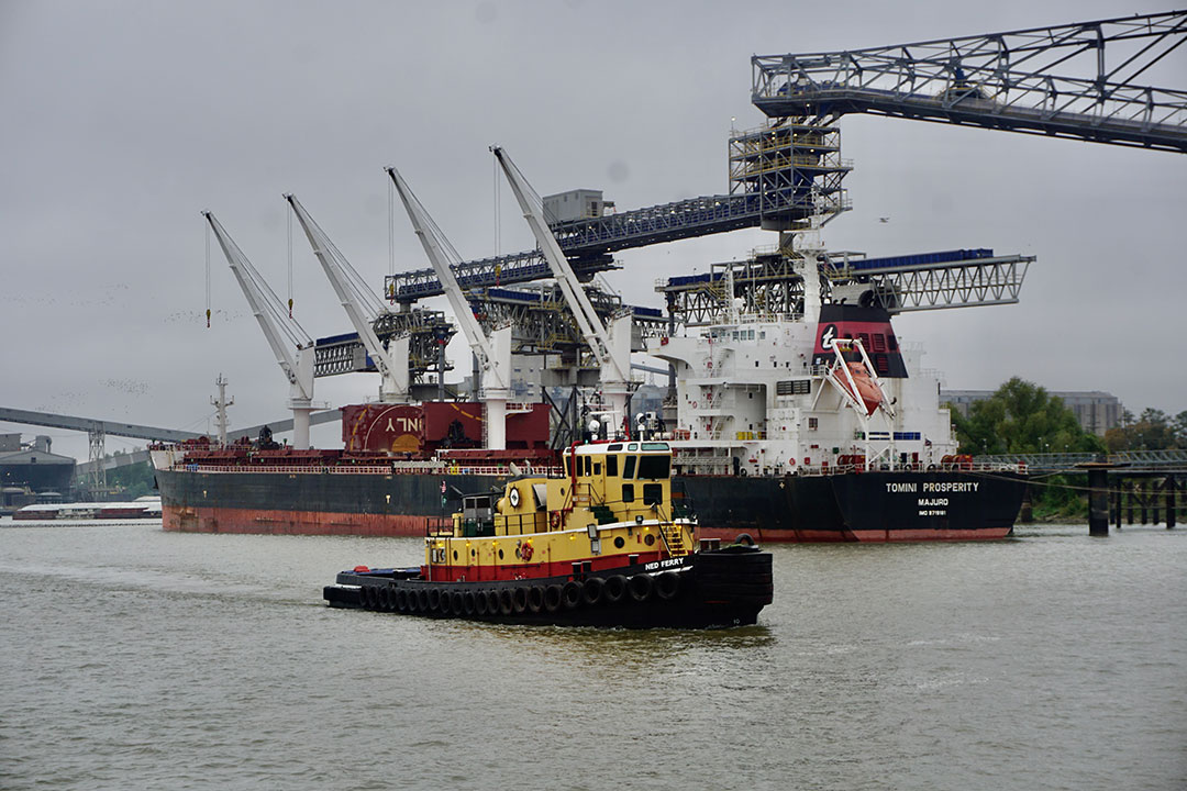 Crescent Towing’s Ned Ferry passes a grain terminal on the Lower Mississippi River.
