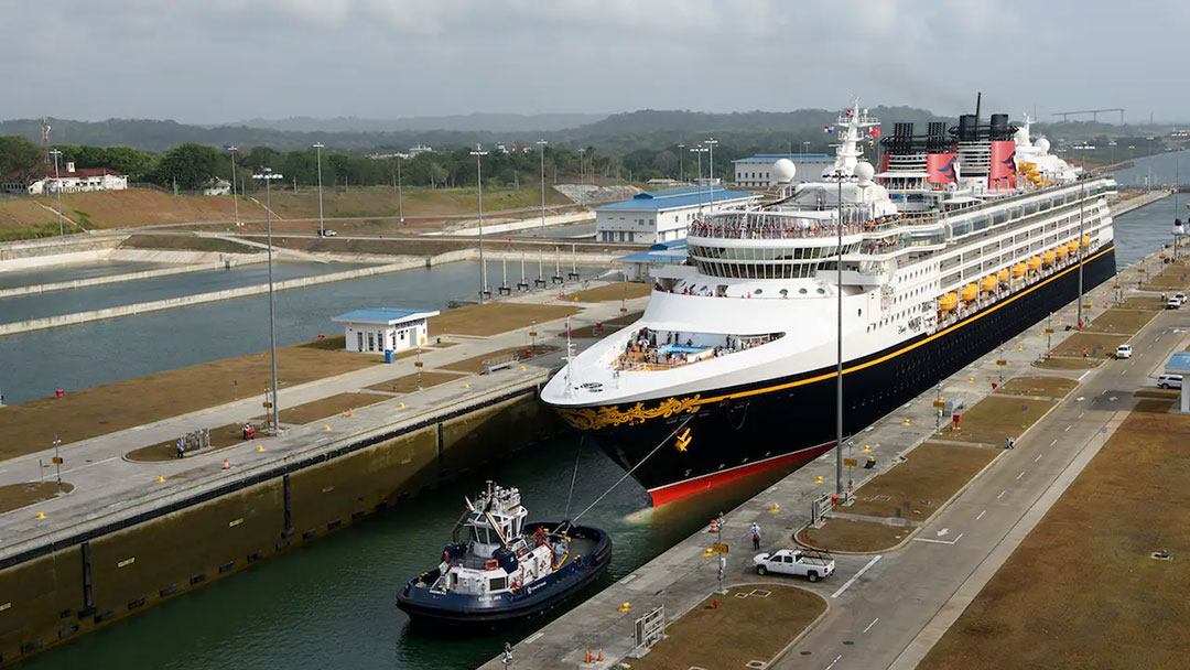 A ship assist tugboat guides a cruise ship into a lock within the Panama Canal. A recent incident close call between a tug and a ship has raised safety concerns. 