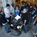 An instructor introduces prospective marine engineers to the workings of a diesel engine.