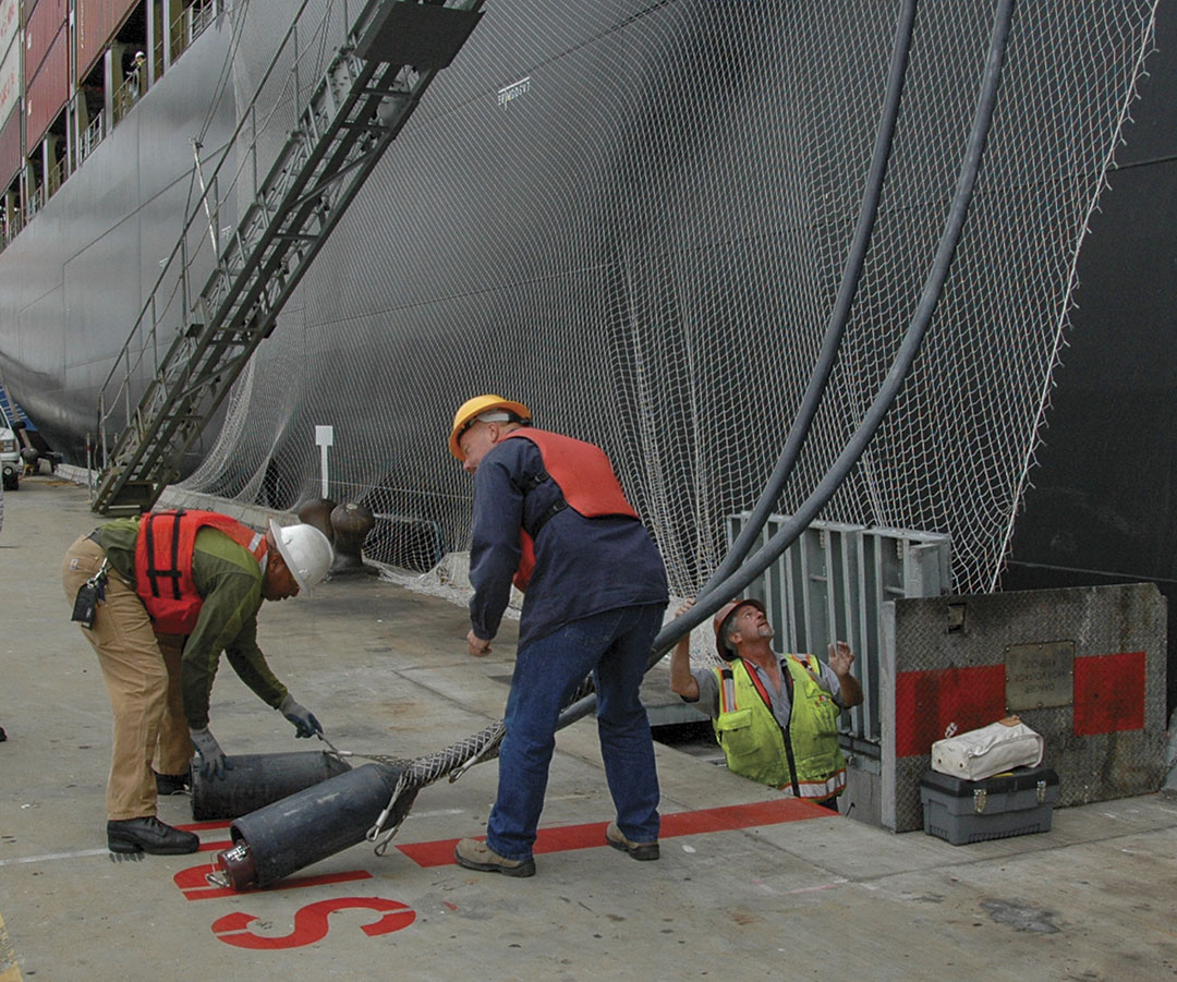 Workers at the Port of Oakland prepare to plug-in a ship berthed at the Ports America Outer Harbor Terminal.  Right, Tim Leong, the Port of Oakland’s senior maritime projects administrator.