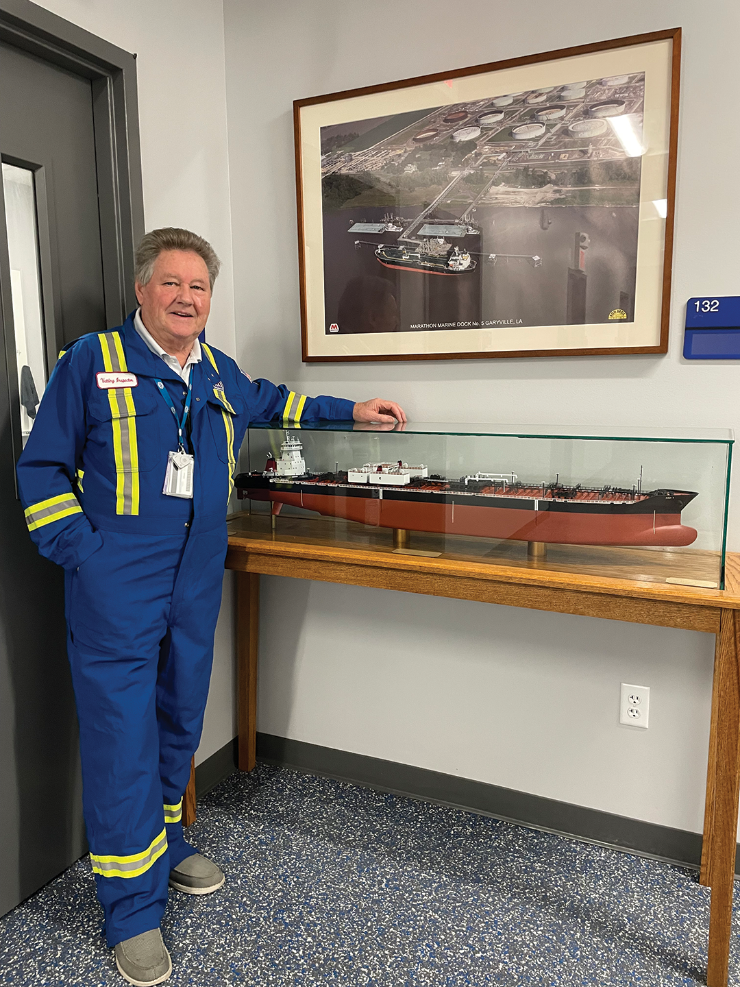 Chief Engineer Jimmy McFadyen with a model of Crowley’s 16,000 hp ATB Liberty and a 330,000 barrel 750-class barge. 