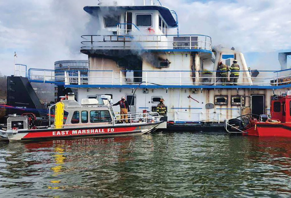 Firefighters battle an engine room fire aboard the Johnny M on Kentucky Lake, just south of Kentucky Lock.