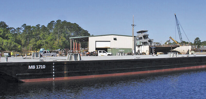 A 140-by-40-foot steel material deck barge with spud wells built at St. Johns Ship Building’s Palatka, Fla., facility, representative of the yard’s recent deliveries to marine construction and dredging customers.