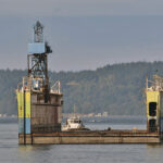 The 820-foot dry dock Hercules is towed into Puget Sound and into service at Everett Ship Repair in September. The Baydelta Maritime tug Delta Deanna, left, relocated the dry dock from San Diego.