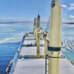 A downbound bulk carrier pushes through a snow-covered ice field on the St. Marys River in December 2025.
