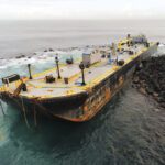 The barge Defiant grounded on the shoreline below Castillo San Felipe del Morro, the historic fort guarding the entrance to San Juan Harbor, on Feb. 9. The petroleum barge was refloated on Feb. 25.