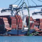 Containers lie scattered in the Port of Long Beach after approximately 95 units fell from the containership Mississippi during cargo operations on Sept. 9, 2025, striking the emissions-control barge STAX 2 and prompting a Coast Guard safety alert on risks to vessels working alongside.