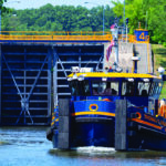 Thomas X. Grasso near a lock on the New York State Canal System. One of four new tugboats being introduced by Canal Corp., the vessel supports maintenance, including icebreaking, across nearly 500 miles of waterways.