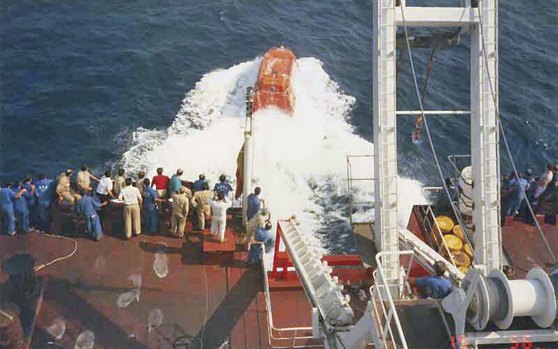 A free-fall lifeboat hits the water during a launch. The U.S. Coast Guard is urging vessel operators to closely inspect aging fiberglass lifeboats, particularly high-stress and load-bearing areas.